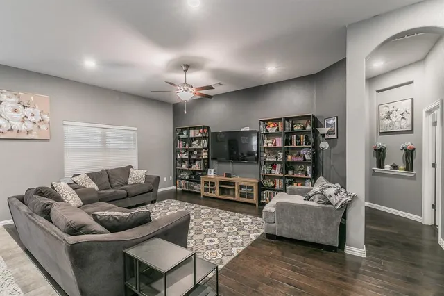 a living room with furniture and a flat screen tv