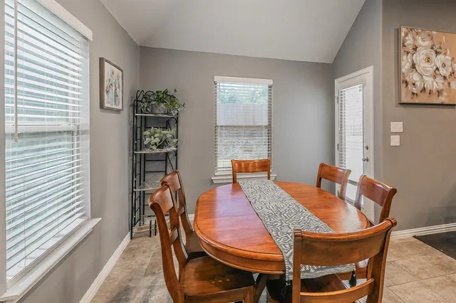 a view of a dining room with furniture and window