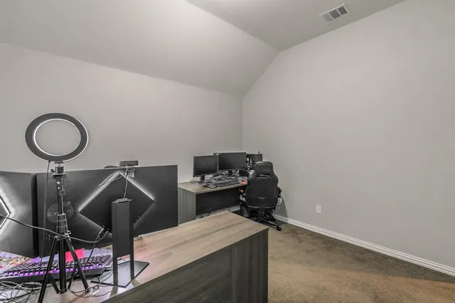 a view of a workspace with furniture and a window