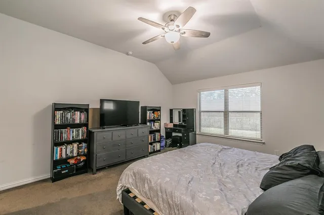 a bedroom with a bed and window