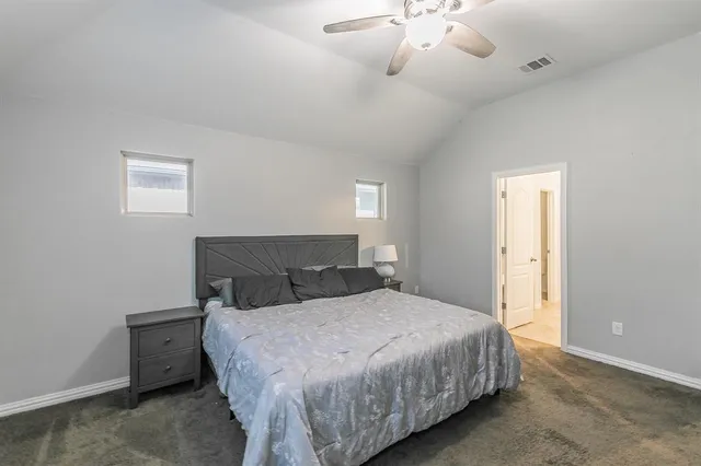 a bedroom with furniture and a flat screen tv