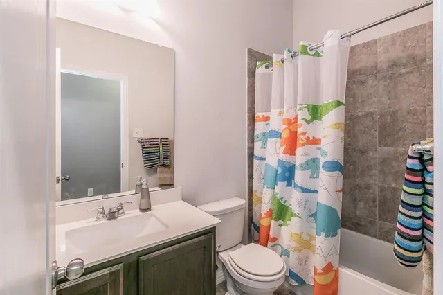 a en suite bathroom with a double vanity sink and a mirror