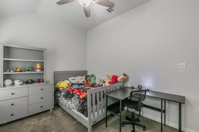 a bedroom with furniture and a flat screen tv