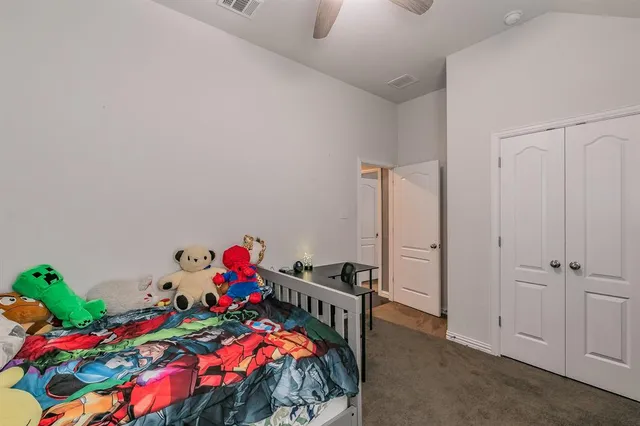 a bedroom with a bed and a desk