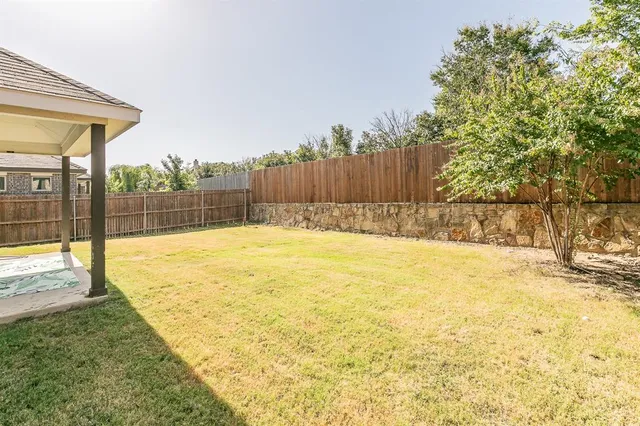 a view of yellow house with a yard