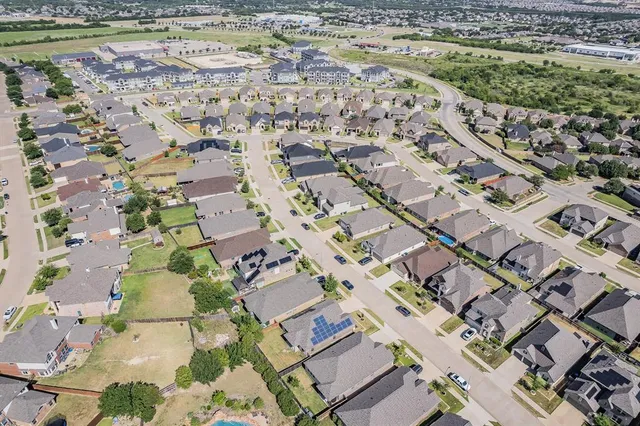 an aerial view of a house with a garden and deck
