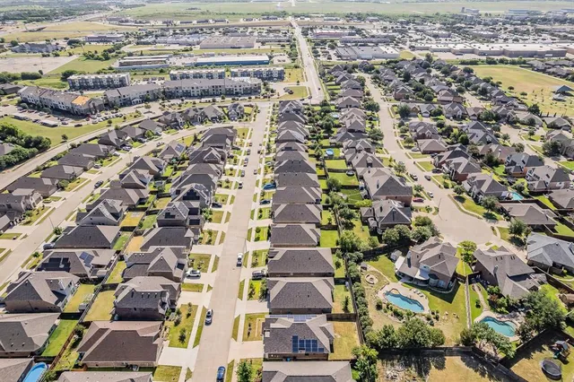 an aerial view of residential houses with outdoor space