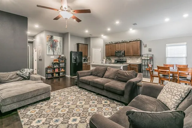 a kitchen with stainless steel appliances granite countertop a sink refrigerator and microwave