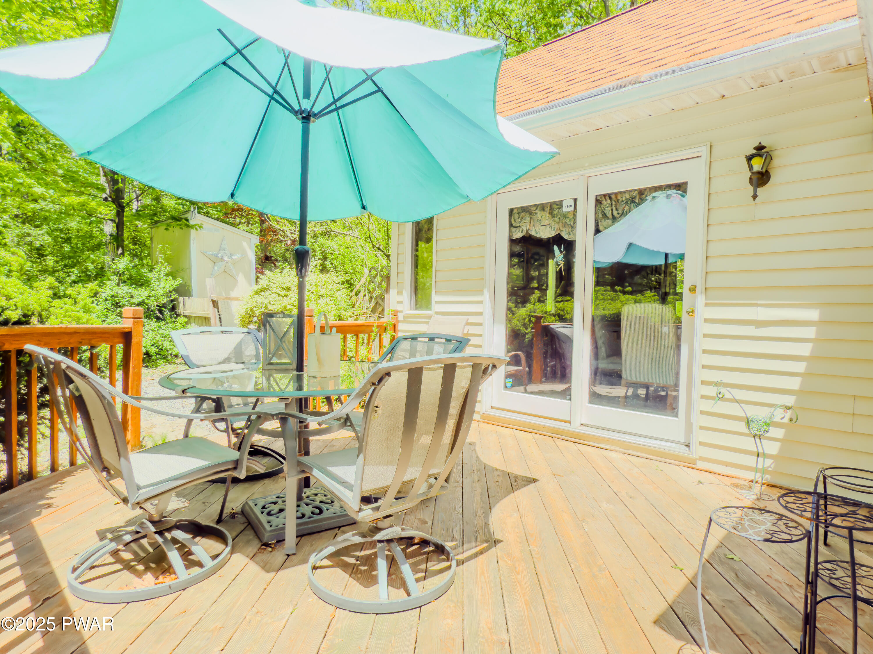 516 Lake Road Hawley, PA 18428 - Photo 7 of 28 a view of a patio with table and chairs under an umbrella