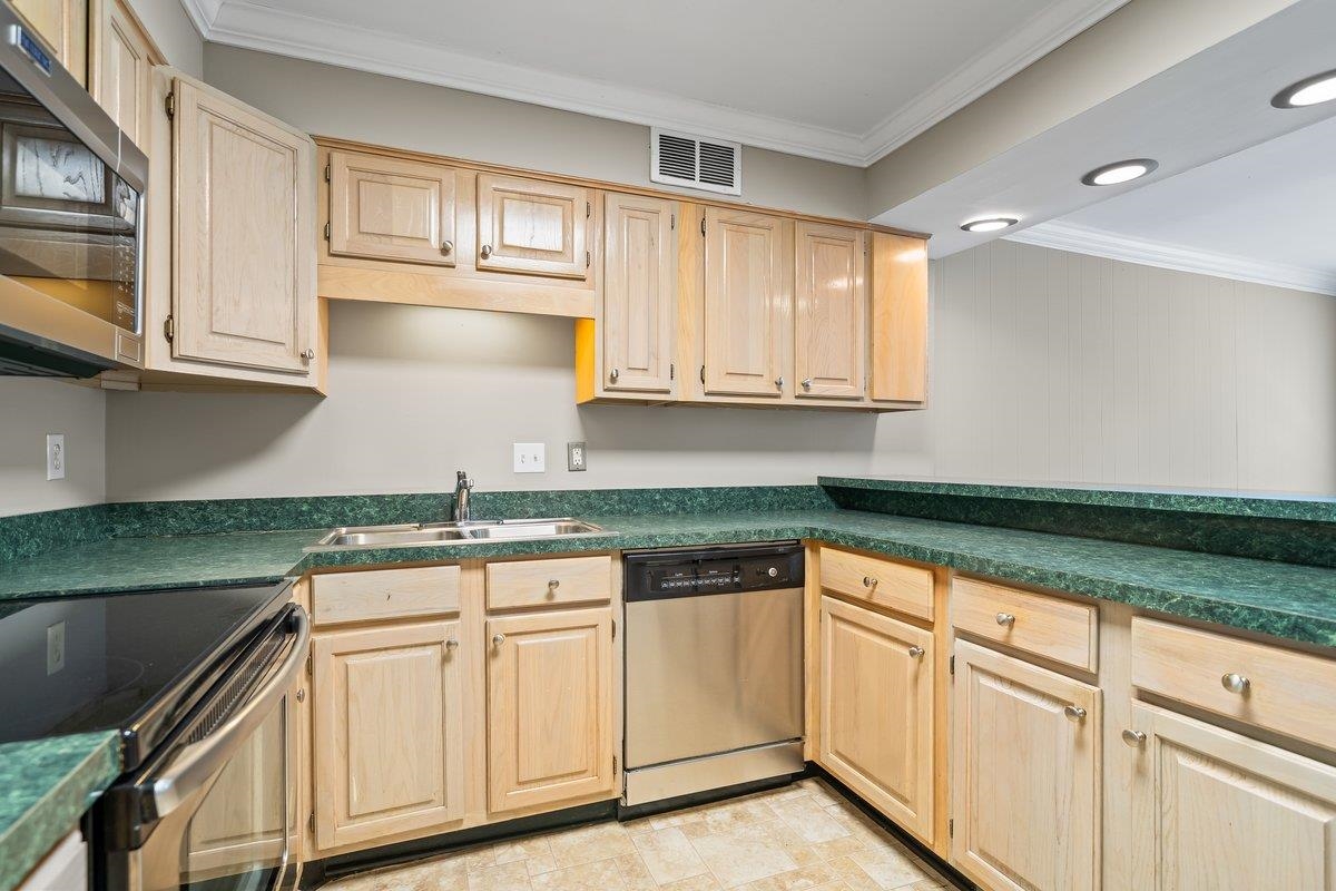 6942 Amberly Road, Unit 6942 Memphis, TN 38119 - Photo 5 of 23 a kitchen with granite countertop white cabinets and white appliances