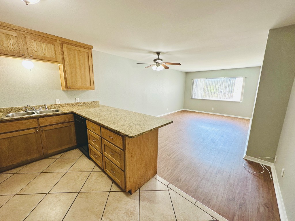 601 West 11th Street, Unit 223 Austin, TX 78701 - Photo 3 of 10 a kitchen with a sink cabinets and wooden floor