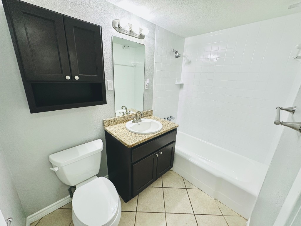 601 West 11th Street, Unit 223 Austin, TX 78701 - Photo 6 of 10 a bathroom with a toilet sink and mirror