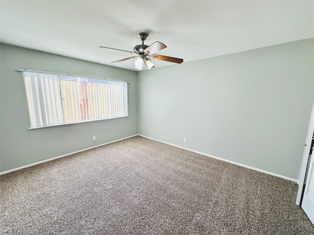 601 West 11th Street, Unit 223 Austin, TX 78701 - Photo 8 of 10 an empty room with windows and fan