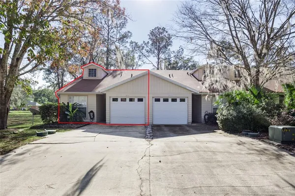 a view of a house with a yard and garage