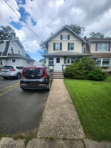 a view of a car parked in front of a house