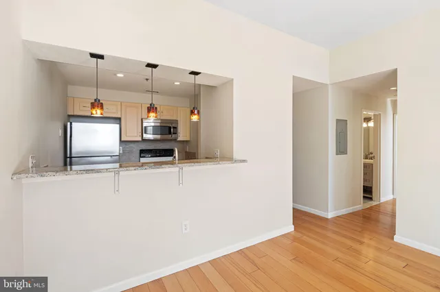 a kitchen with stainless steel appliances a refrigerator and a stove top oven
