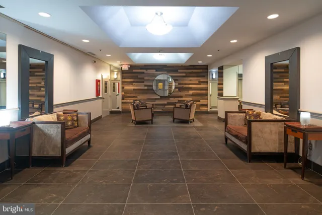 a living room with lots of furniture and kitchen view