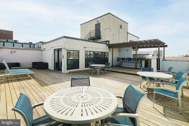 a view of a patio with table and chairs