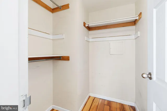 a view of an empty room and wooden floor