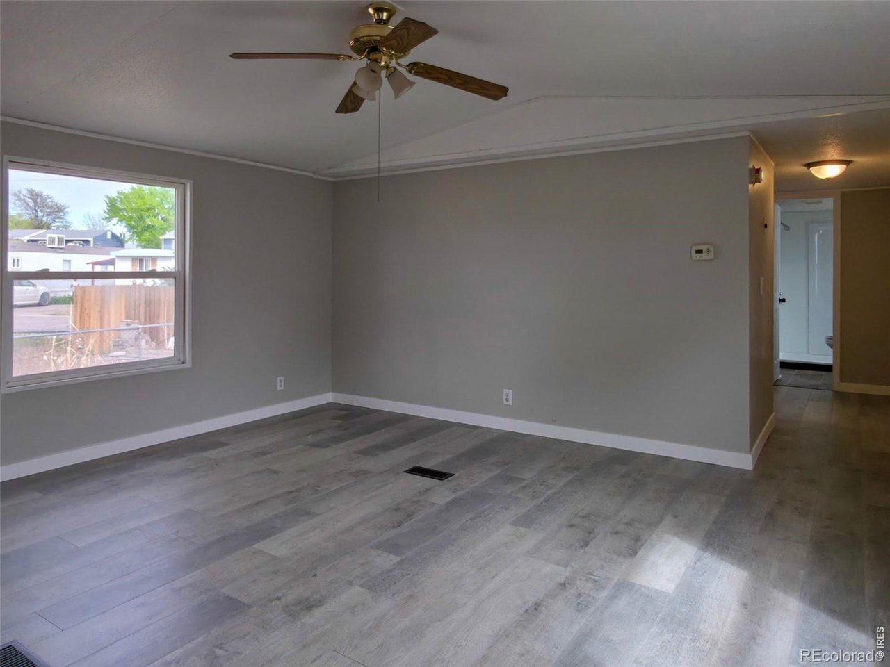 1401 9th Street, Unit 80 Fort Lupton, CO 80621 - Photo 15 of 21 wooden floor in an empty room with a window