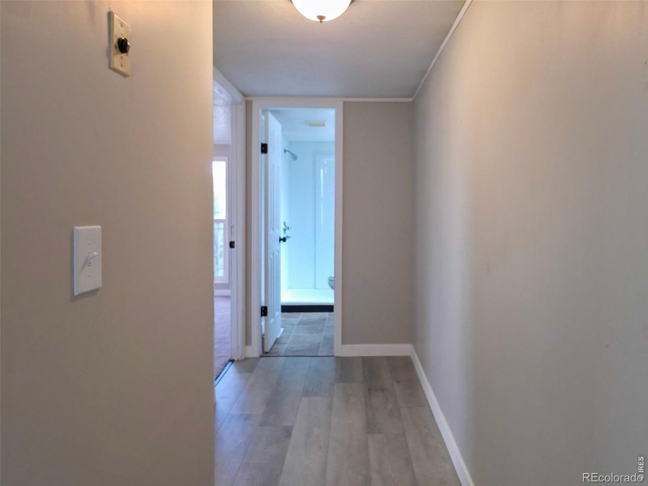 1401 9th Street, Unit 80 Fort Lupton, CO 80621 - Photo 16 of 21 a view of a hallway with wooden floor