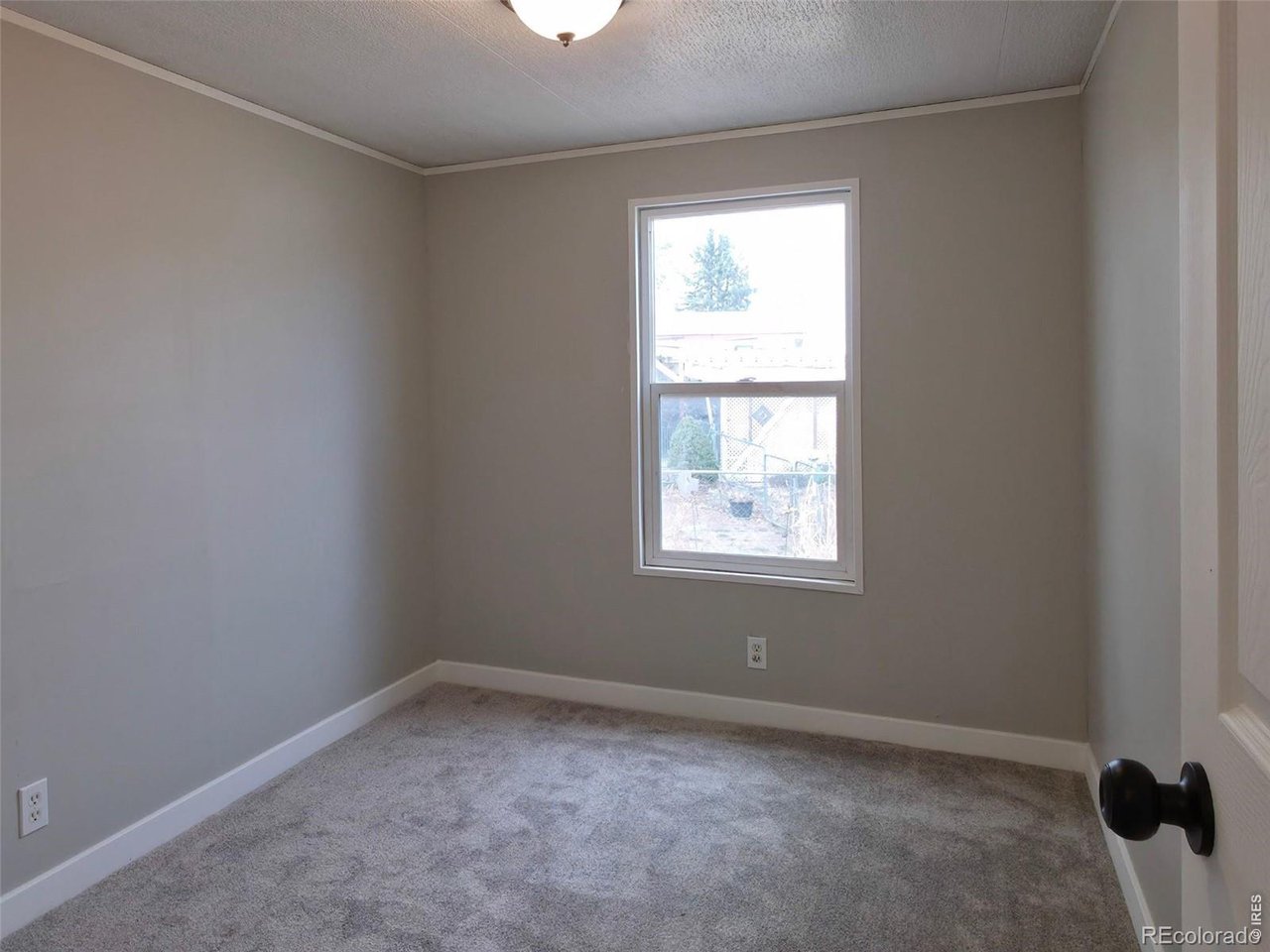 1401 9th Street, Unit 80 Fort Lupton, CO 80621 - Photo 18 of 21 an empty room with a window
