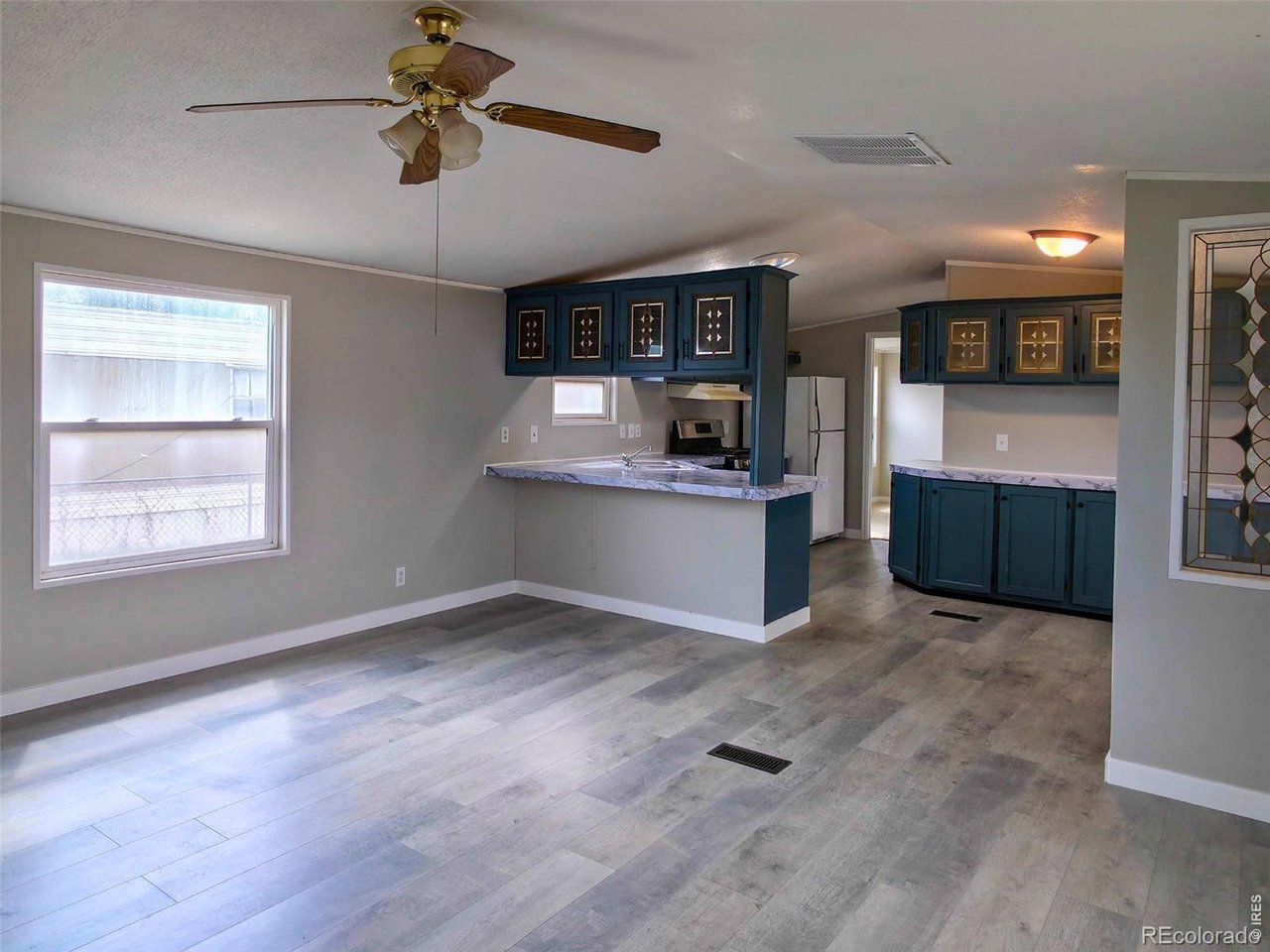 1401 9th Street, Unit 80 Fort Lupton, CO 80621 - Photo 4 of 21 a view of kitchen with microwave and cabinets