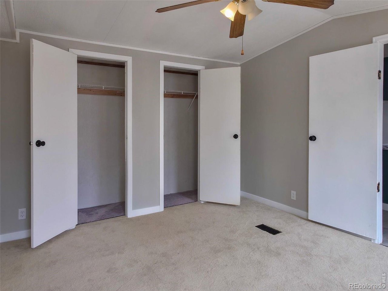 1401 9th Street, Unit 80 Fort Lupton, CO 80621 - Photo 9 of 21 a view of an empty room with a ceiling fan