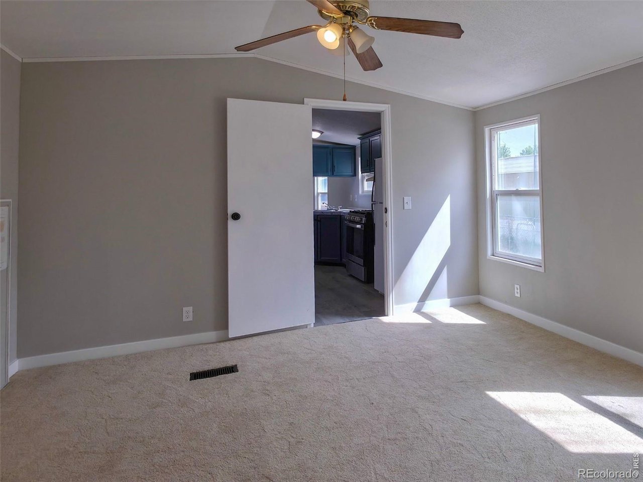 1401 9th Street, Unit 80 Fort Lupton, CO 80621 - Photo 10 of 21 a view of a livingroom with a ceiling fan and window