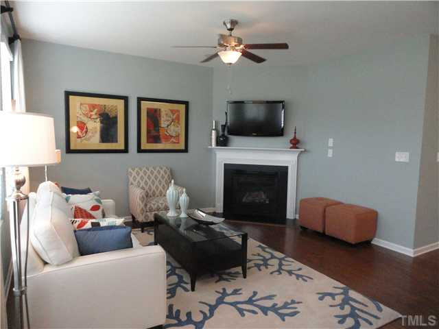 4400 Hargrove Road Raleigh, NC 27604 - Photo 5 of 10 a living room with furniture a flat screen tv and a fireplace