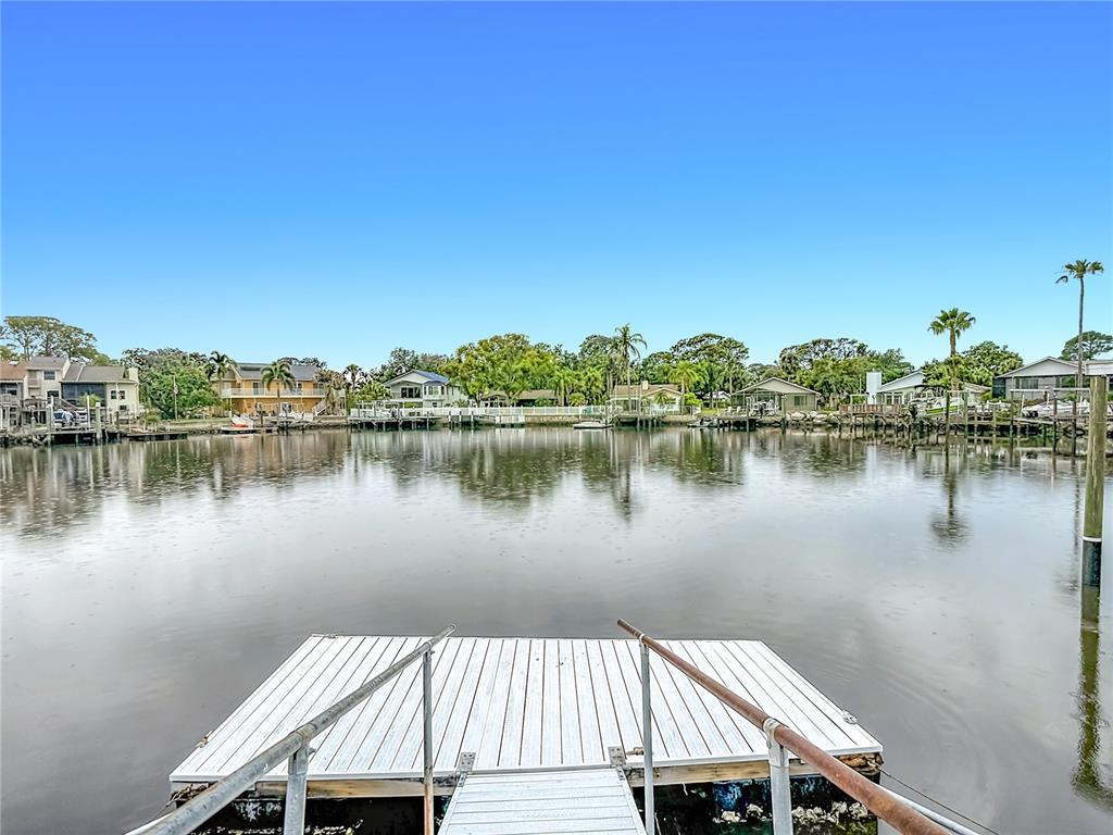 4536 Mitcher Road New Port Richey, FL 34652 - Photo 46 of 46 a view of a lake with a house in the background
