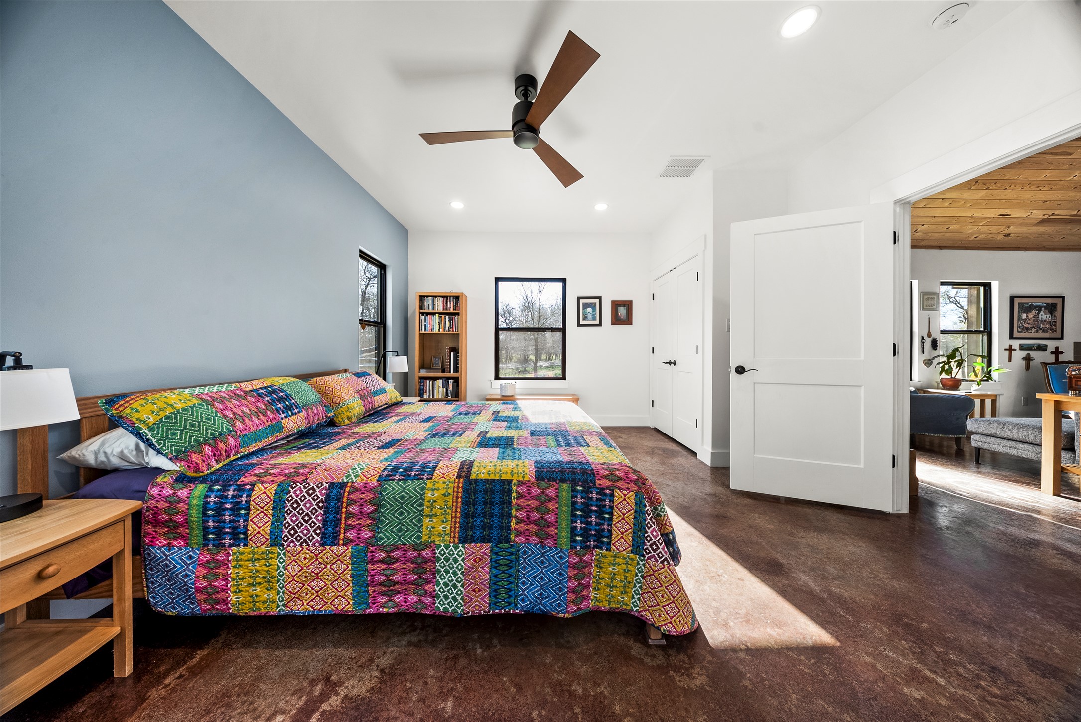 153 County Road 491 Elgin, TX 78621 - Photo 12 of 40 a bedroom with a bed and a baby crib with wooden floor