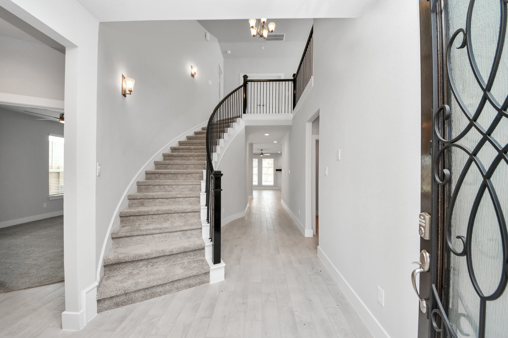 3102 Native Spg Drive Spring, TX 77373 - Photo 5 of 40 The majestic entryway allures with its high ceilings, embellished with sophisticated wood-look tile flooring and sleek oversized baseboards. Lift your eyes to a captivating sight of the open staircase, and follow the trail of natural light pouring in through expansive windows as you journey to the family room, crafting an inviting and cozy ambiance. Sample photo of completed home with similar floor plan. Actual colors and selections may vary.