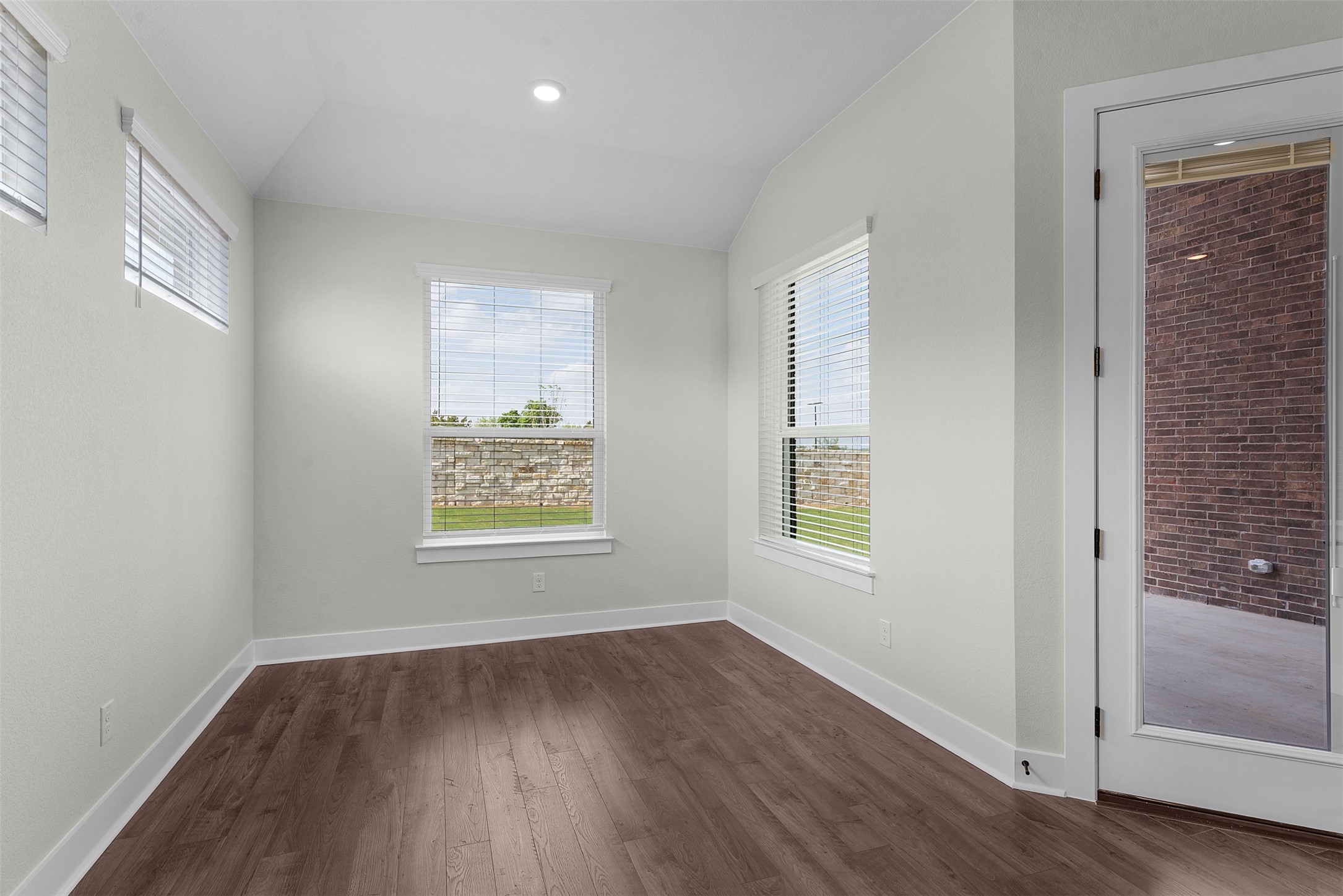 1121 Pansy Trail Georgetown, TX 78628 - Photo 10 of 25 Empty room with dark wood-type flooring, healthy amount of natural light, lofted ceiling, and recessed lighting