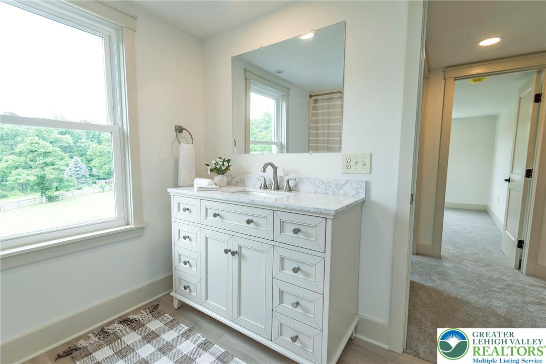 72 Allegheny Road Mount Bethel, PA 18343 - Photo 36 of 72 A well-appointed bathroom vanity offers a bright marble countertop and ample storage beneath a large mirror.