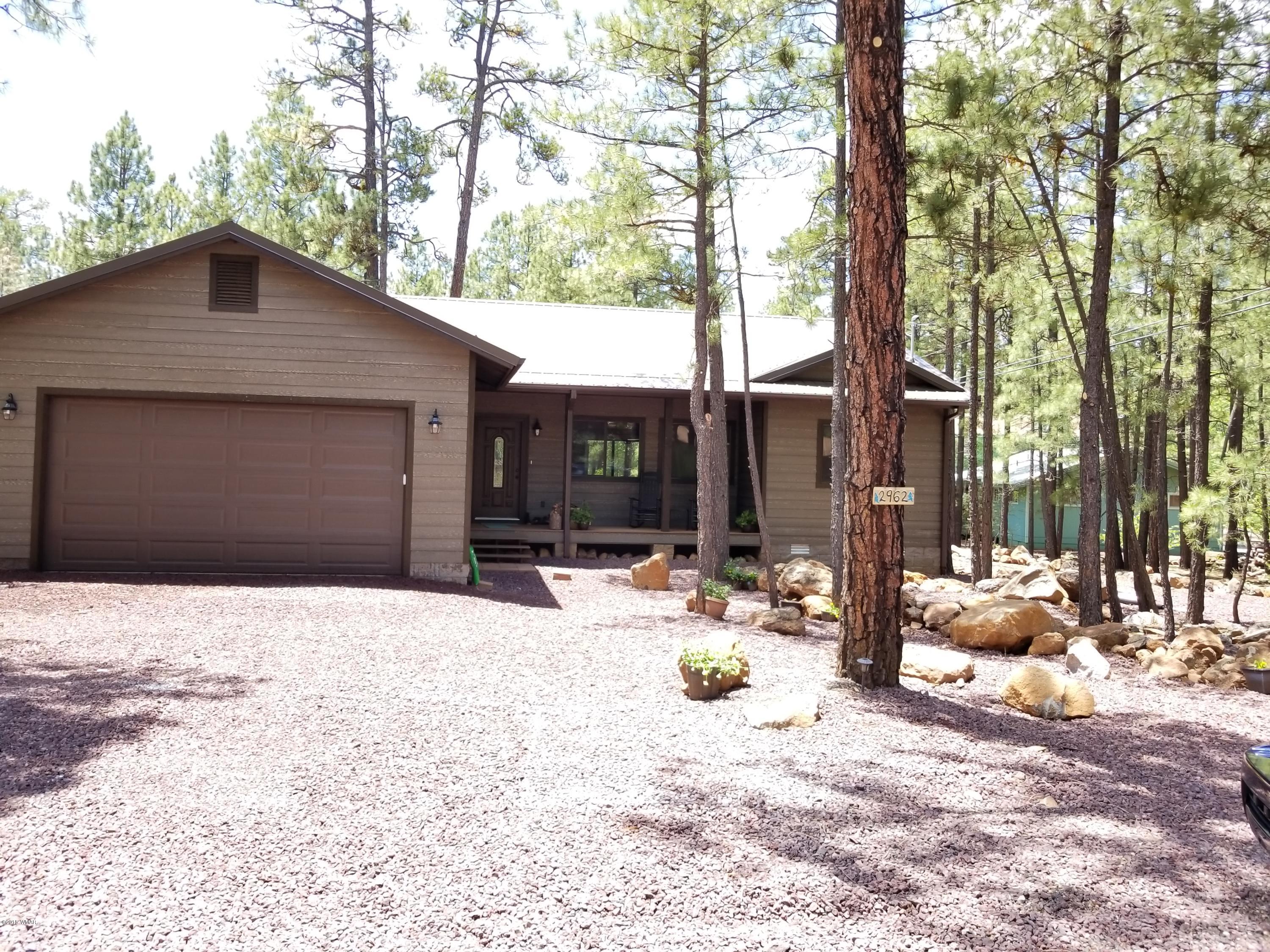 2962 Chestnut Circle, Unit 3 Pinetop, AZ 85935 - Photo 1 of 35 a backyard of a house with table and chairs and floor to ceiling window