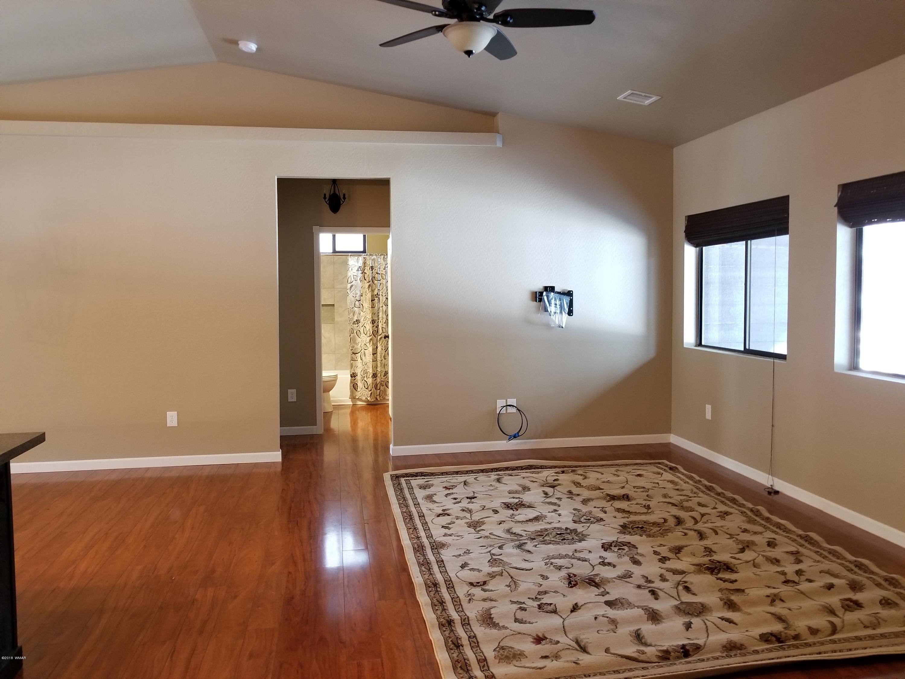 2962 Chestnut Circle, Unit 3 Pinetop, AZ 85935 - Photo 11 of 35 wooden floor in an empty room with a window