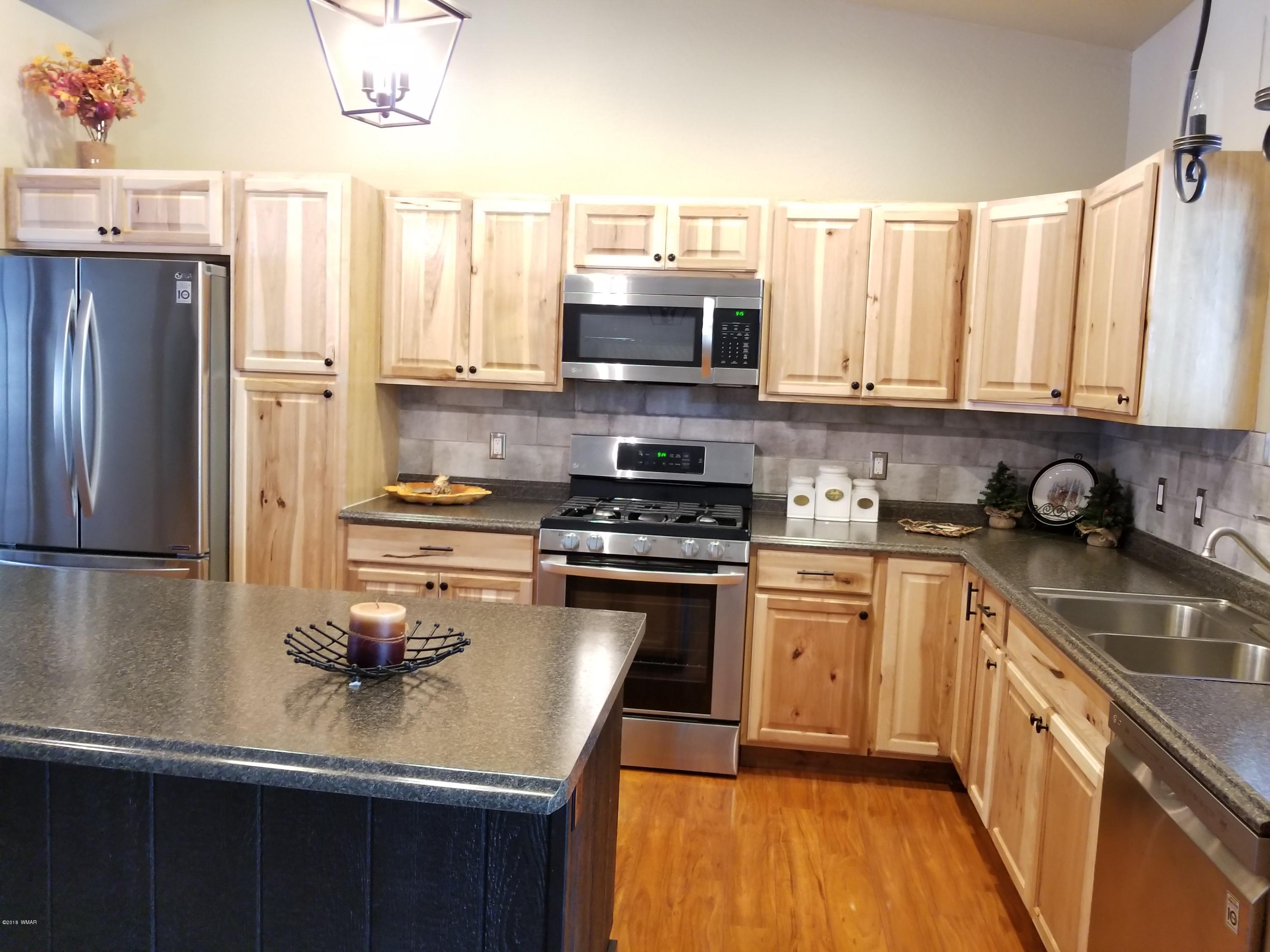 2962 Chestnut Circle, Unit 3 Pinetop, AZ 85935 - Photo 13 of 35 a kitchen with stainless steel appliances granite countertop a sink stove refrigerator and cabinets