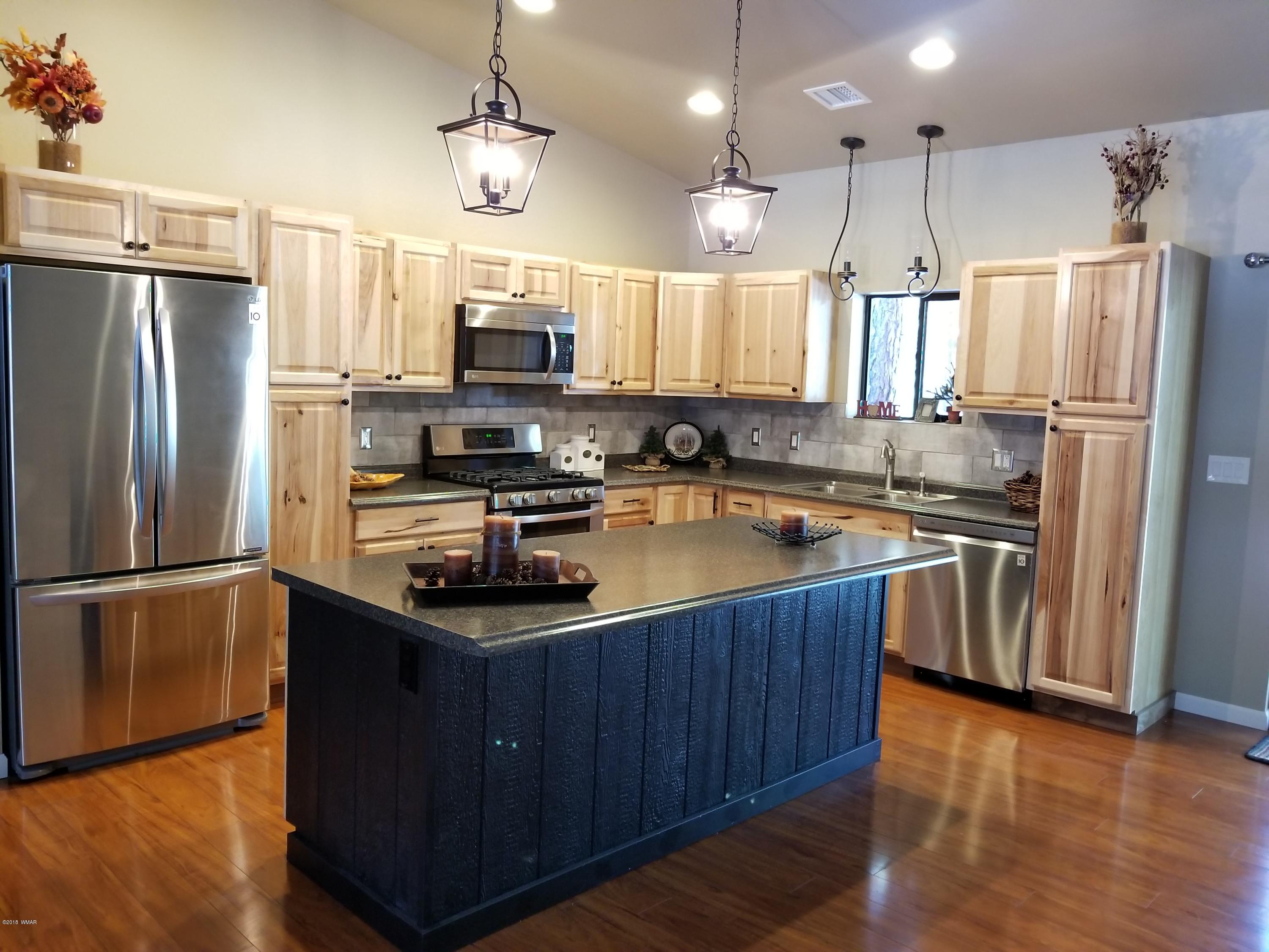 2962 Chestnut Circle, Unit 3 Pinetop, AZ 85935 - Photo 14 of 35 a kitchen with a refrigerator a sink and wooden floor