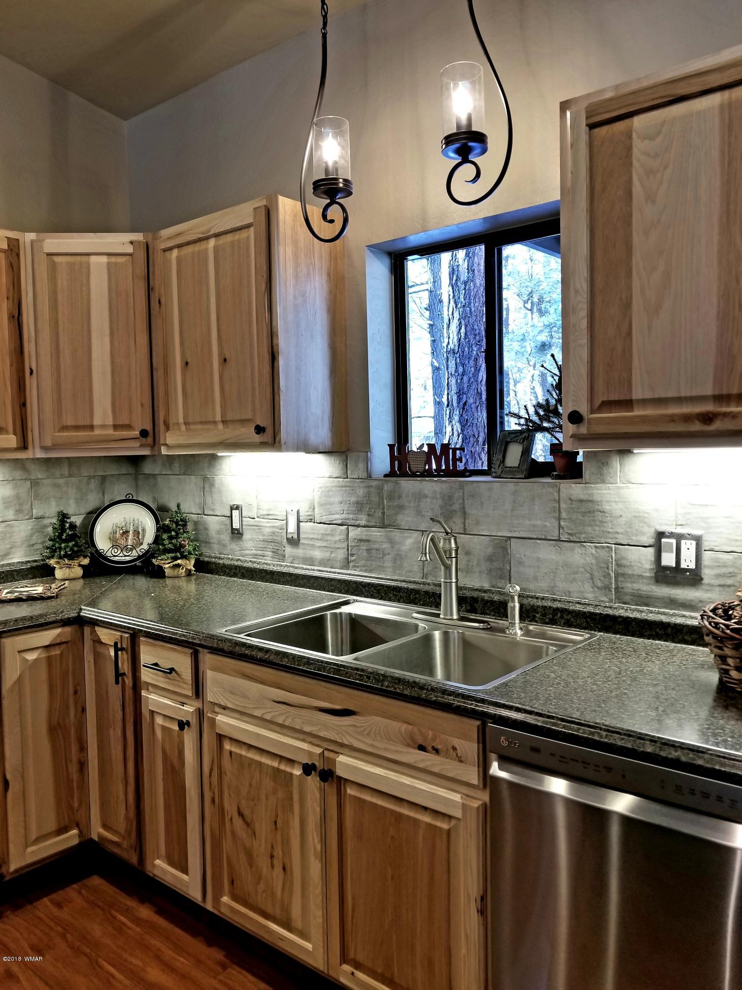 2962 Chestnut Circle, Unit 3 Pinetop, AZ 85935 - Photo 16 of 35 a kitchen with stainless steel appliances granite countertop a sink a stove and cabinets