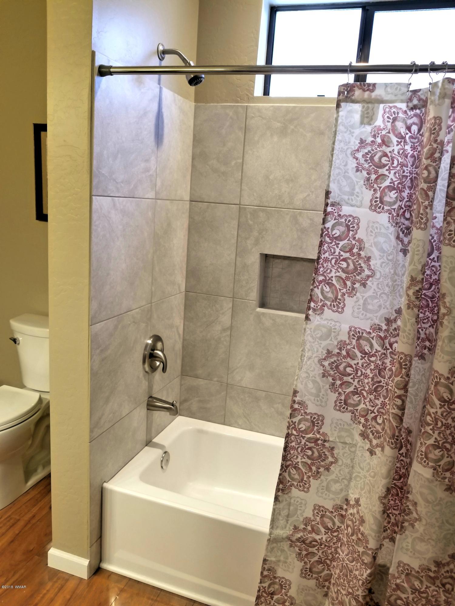 2962 Chestnut Circle, Unit 3 Pinetop, AZ 85935 - Photo 24 of 35 a bathroom with a bathtub and shower