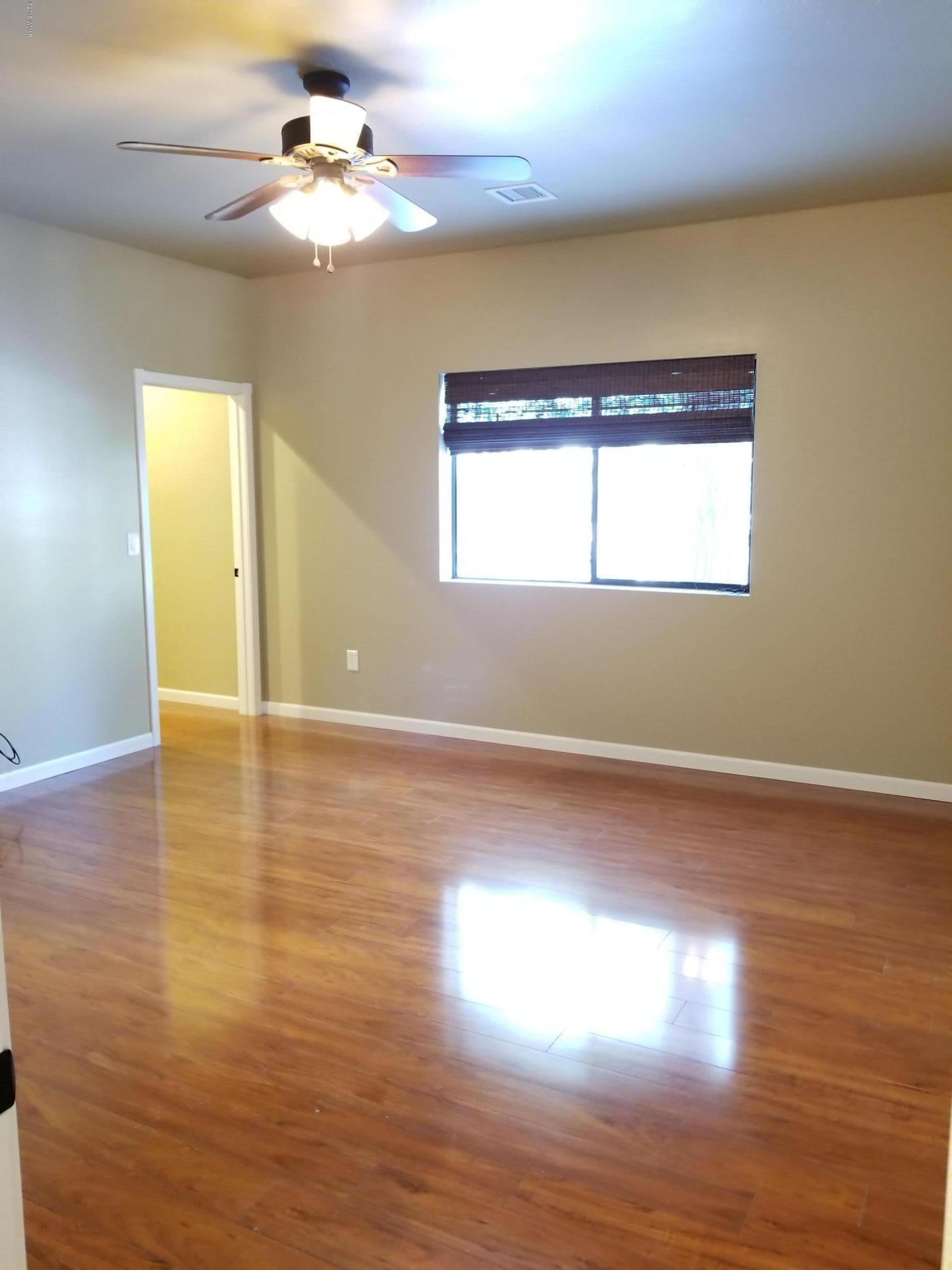 2962 Chestnut Circle, Unit 3 Pinetop, AZ 85935 - Photo 29 of 35 a view of an empty room with wooden floor and a window