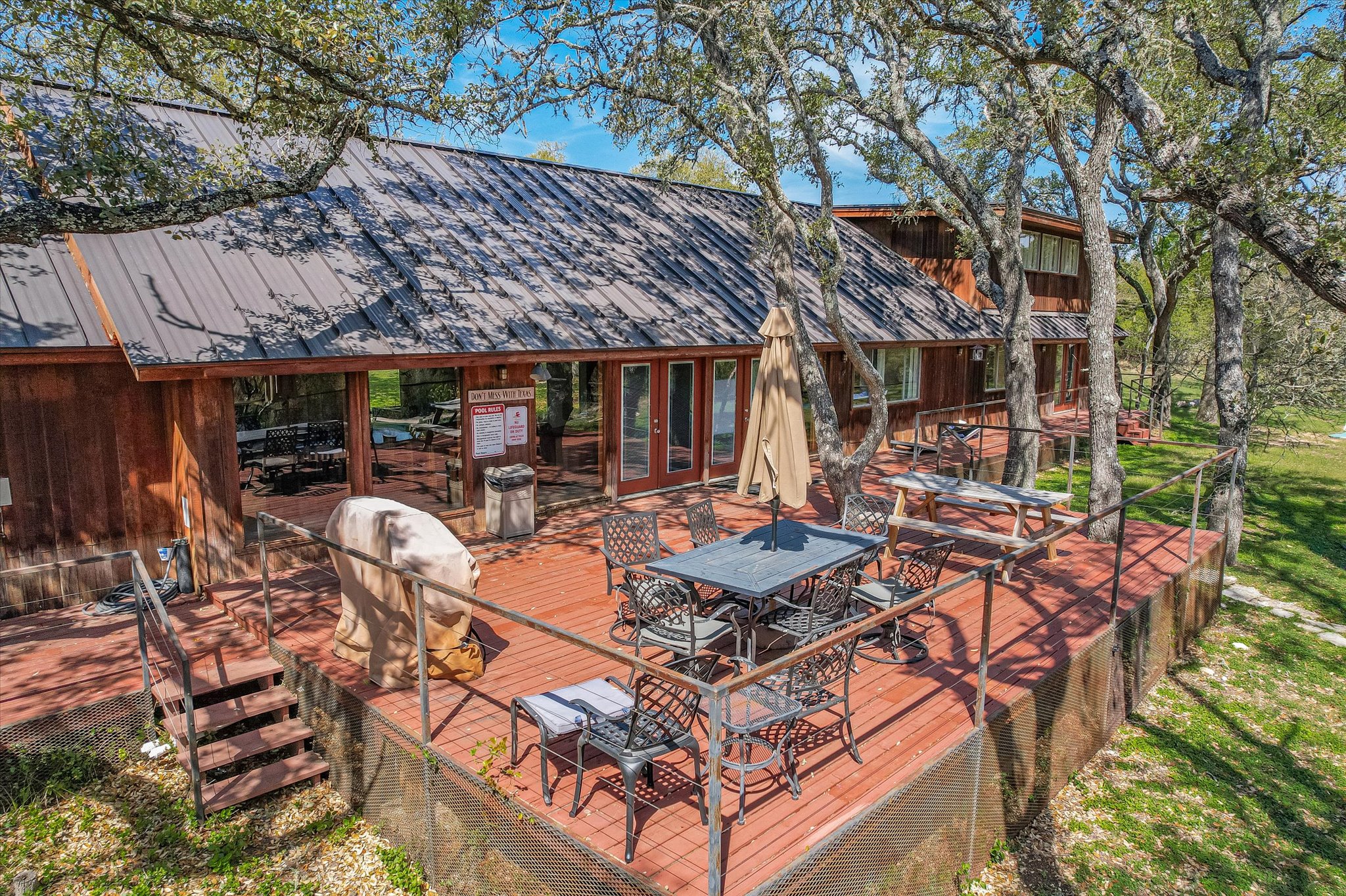 411 Whitetail Ridge Austin, TX 78737 - Photo 31 of 38 Wooden terrace featuring outdoor dining area and grilling area