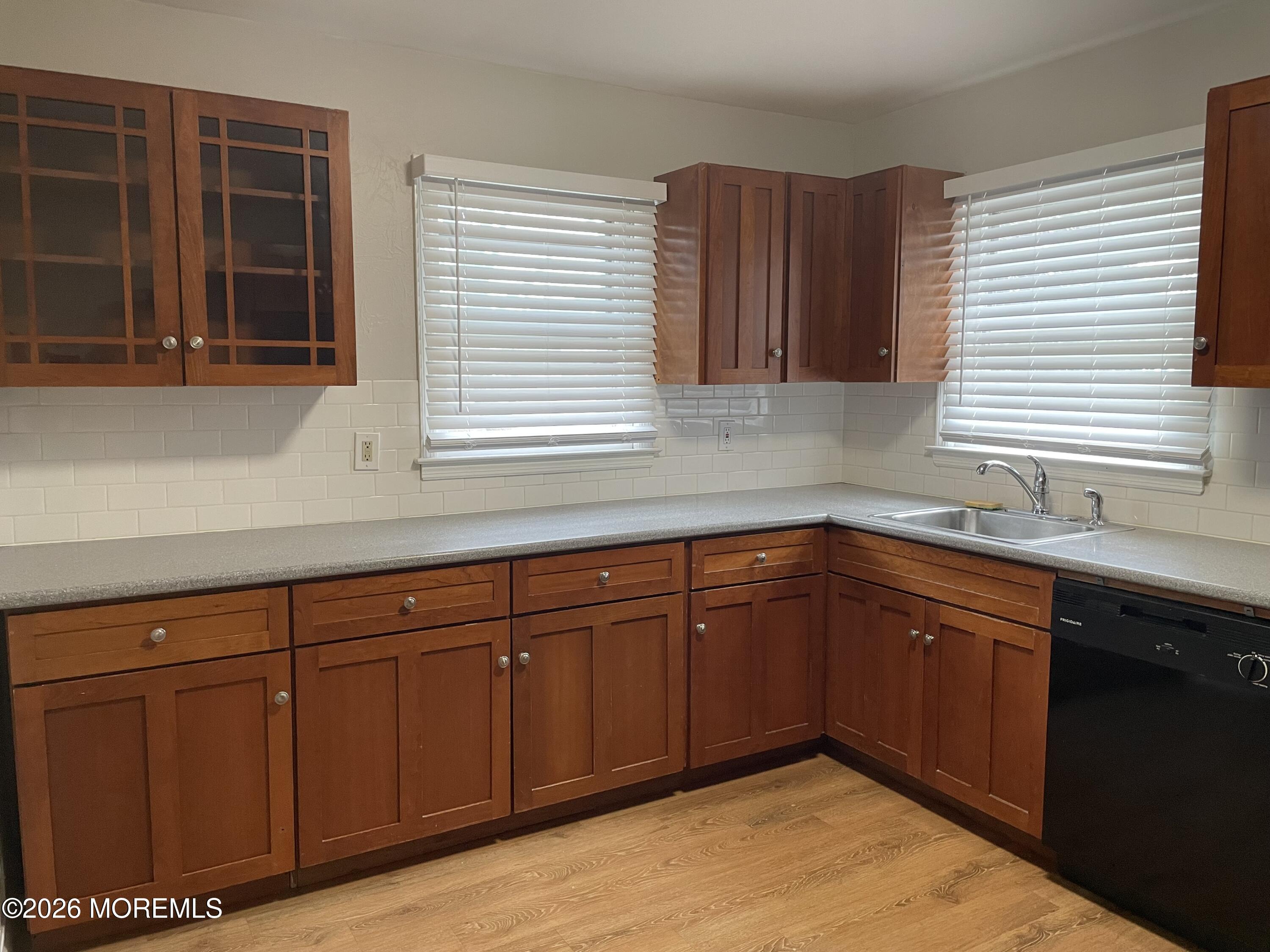 13 Johnson Avenue, Unit 2 Matawan, NJ 07747 - Photo 3 of 10 a kitchen with stainless steel appliances granite countertop wooden cabinets a sink and a window