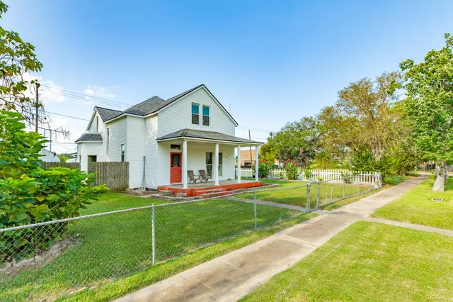 a front view of a house with swimming pool having outdoor seating