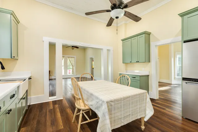 a dining room with a wooden table and chairs