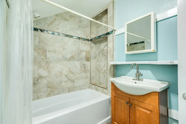 a bathroom with a sink a mirror and a bathtub