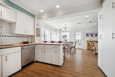 a kitchen with a sink cabinets and wooden floor