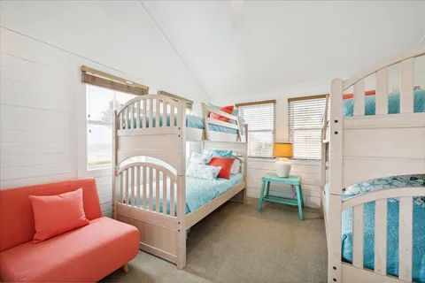 a bedroom with furniture and a window