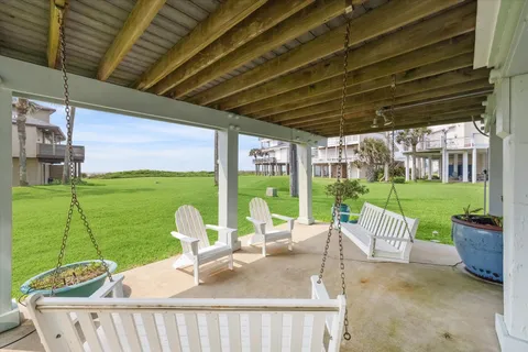 a view of a patio with a table chairs and a backyard